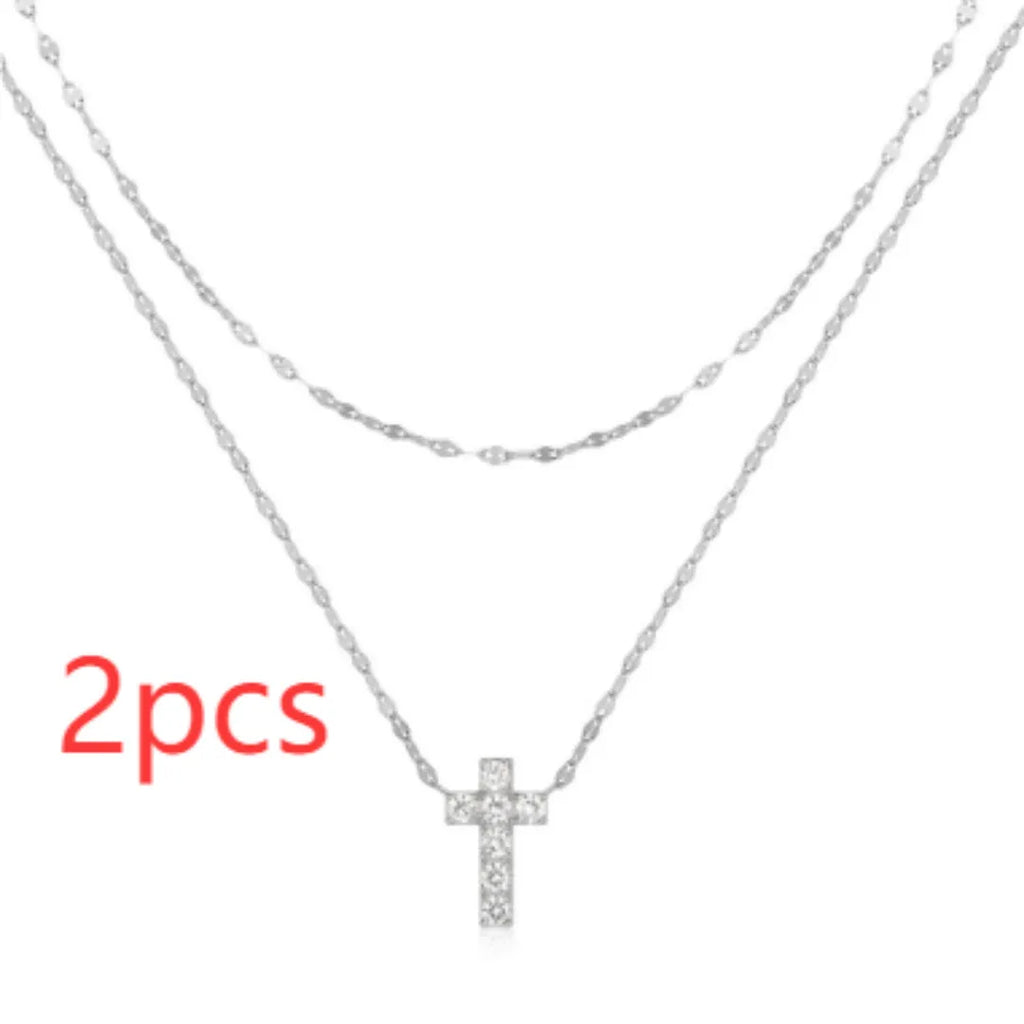 S925 sterling silver double layer cross pendant necklace with diamond accents on a clavicle chain.