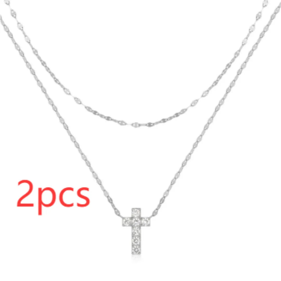 S925 sterling silver double layer cross pendant necklace with diamond accents on a clavicle chain.