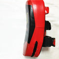 Black and red square hand-held martial arts kick pad with a double buckle strap on the back.