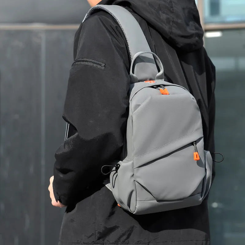 Men's black casual crossbody bag made from waterproof polyester with an adjustable shoulder strap.