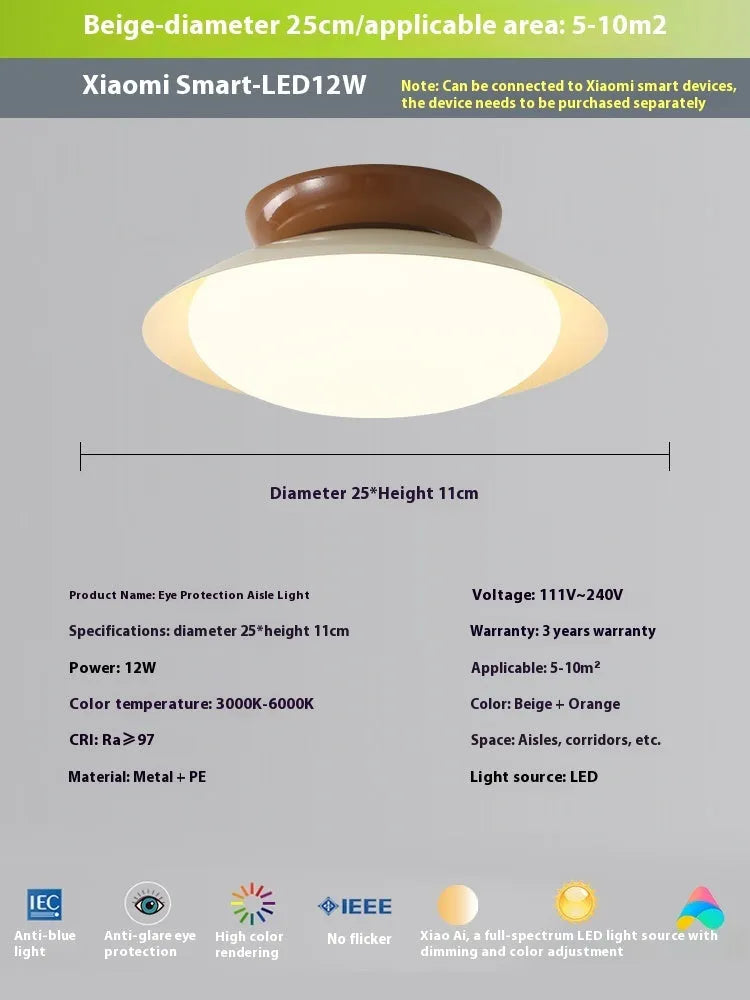 Modern flying saucer shaped ceiling lamp with an iron shade, shown in a cream yellow finish.