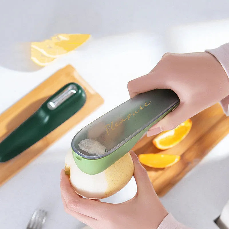 Dark green vegetable peeler with stainless steel blade and plastic storage tube
