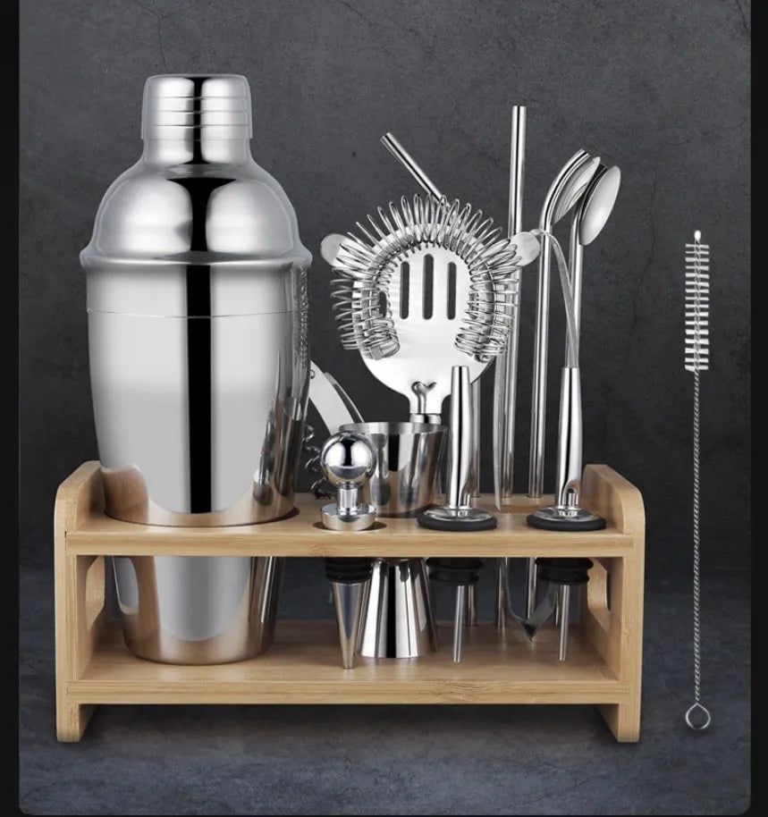 23-piece stainless steel and acrylic cocktail set with shakers and bar tools on a counter.