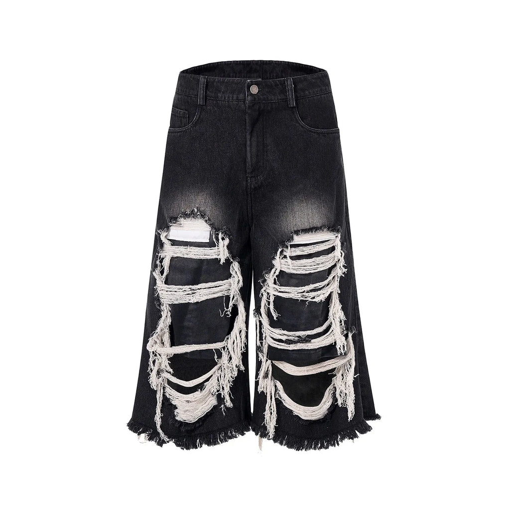 Black wide leg cropped jeans with mid-high waist and ripped patch detail on micro-elastic cotton denim