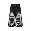 Black wide leg cropped jeans with mid-high waist and ripped patch detail on micro-elastic cotton denim