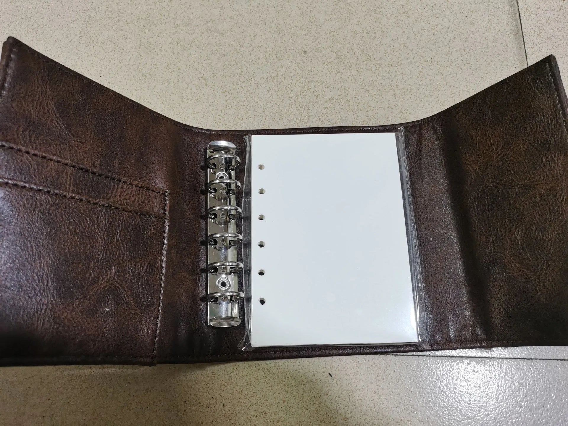 Brown A7 notebook with loose-leaf binder binding and PU cover
