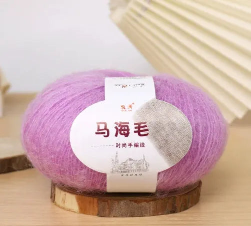 DIY mohair scarf weaving kit showing one wool ball and a selection of 34 colour options including white, pink, blue and green.