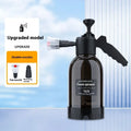 Black hand-held spray sprayer with 2 litre capacity, ergonomic handle, and two nozzles for watering and cleaning.