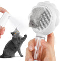 Grey spray function pet brush with stainless steel bristles and a self-cleaning button on the handle.