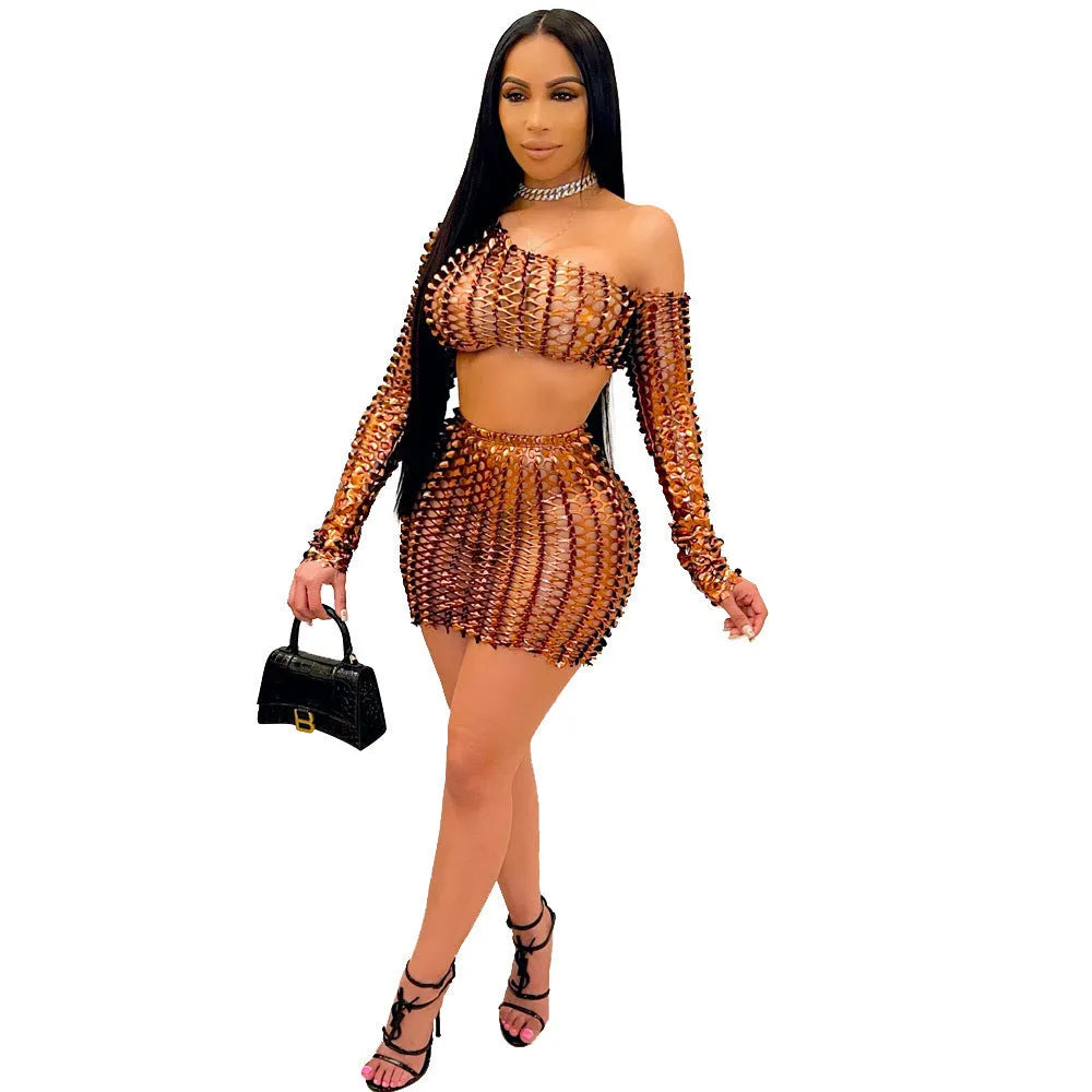 Black hollow-out two-piece dress set with sleeveless top and short skirt on a mannequin.
