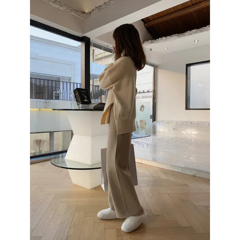 Women's high waist wide-leg knit trousers in cream white colour, laid flat to show straight-leg cut.