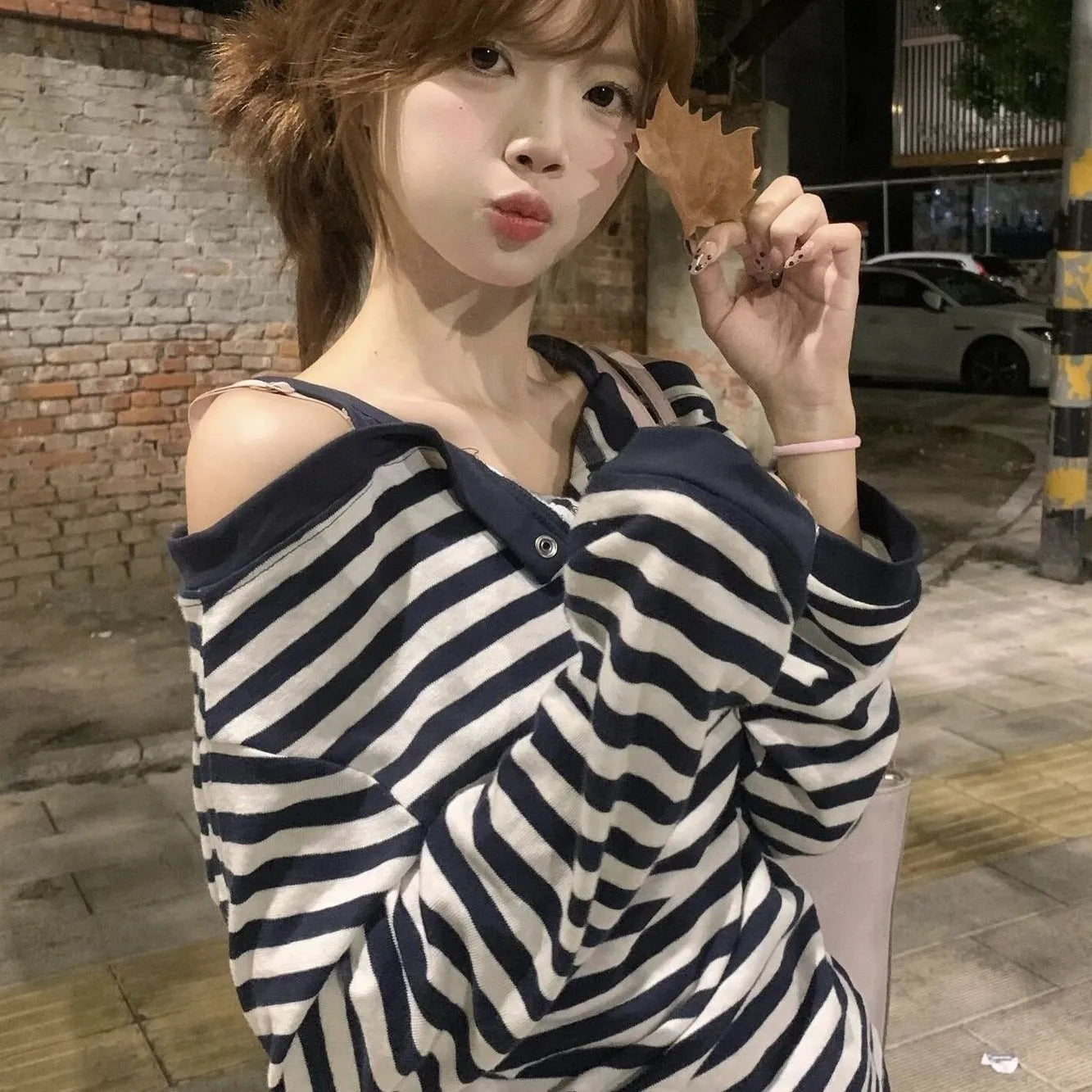 Dark blue Korean-style oversized women's long-sleeved t-shirt with embroidered stripes and button details.