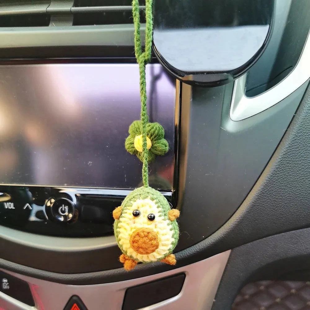Handmade crocheted wool car pendant in avocado, pink rainbow, or red rainbow colours with cartoon styling