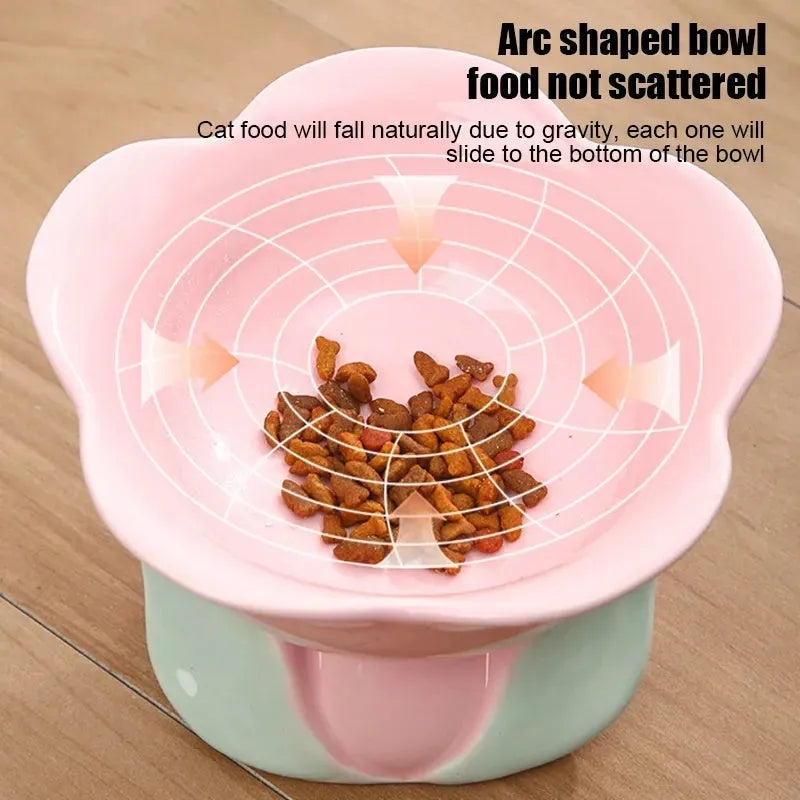 Blue ceramic elevated pet bowl with floral pattern and non-slip base for cats or small dogs.