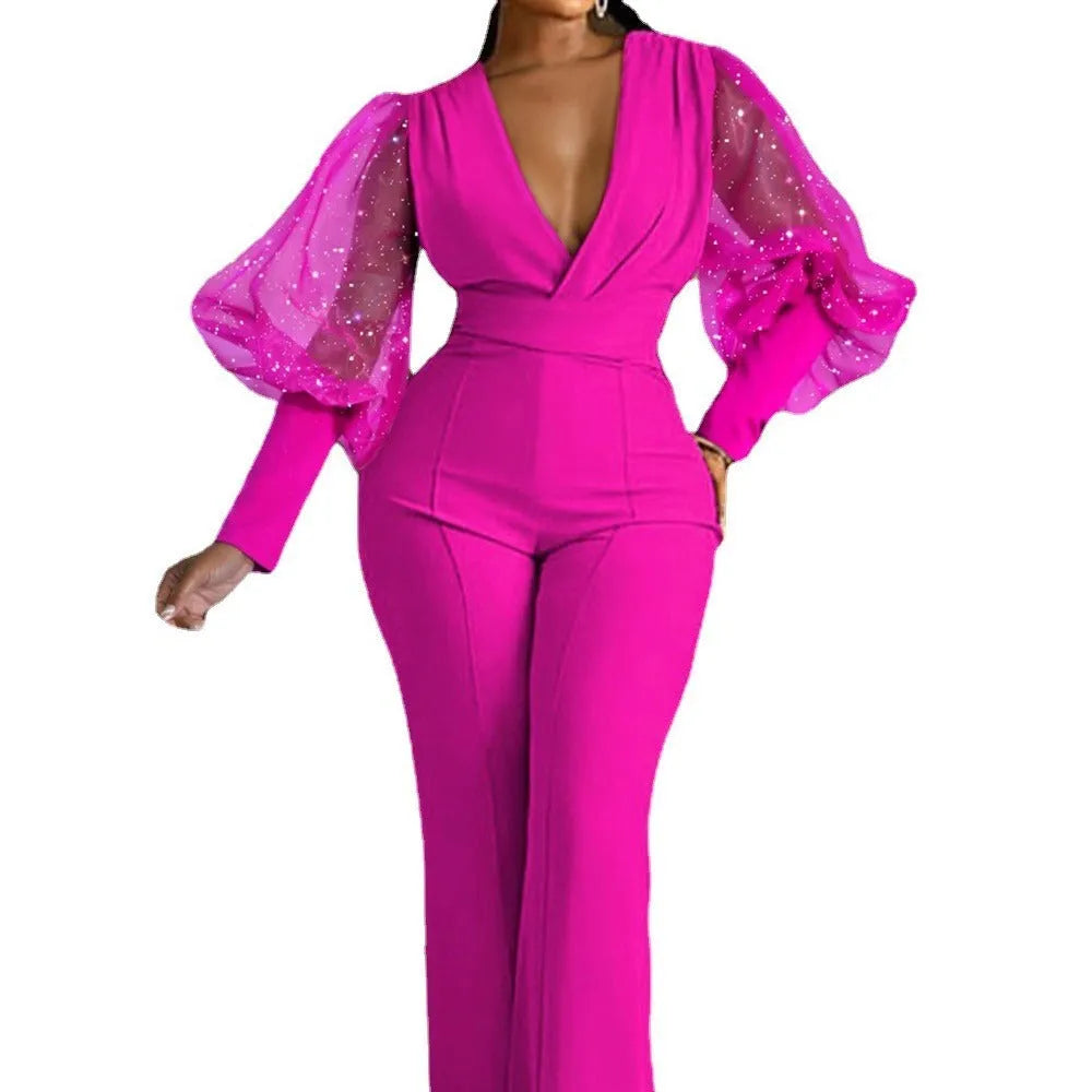 A woman wearing a red wide-leg jumpsuit with long sleeves and an elasticated waist.