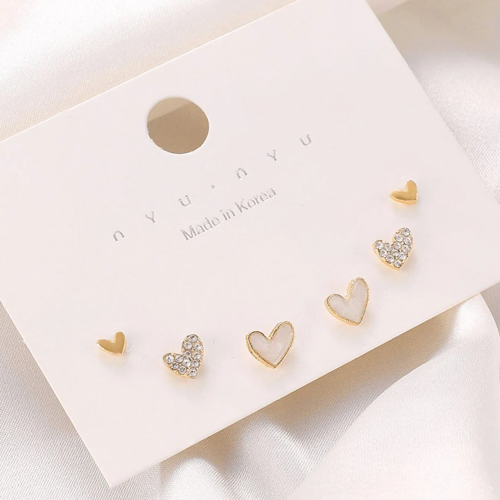 Three pairs of heart-shaped alloy earrings with love motifs in four colour options