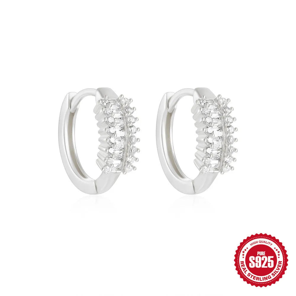 Small round geometric sterling silver stud earrings with a diamond shape, available in gold or silver finish.