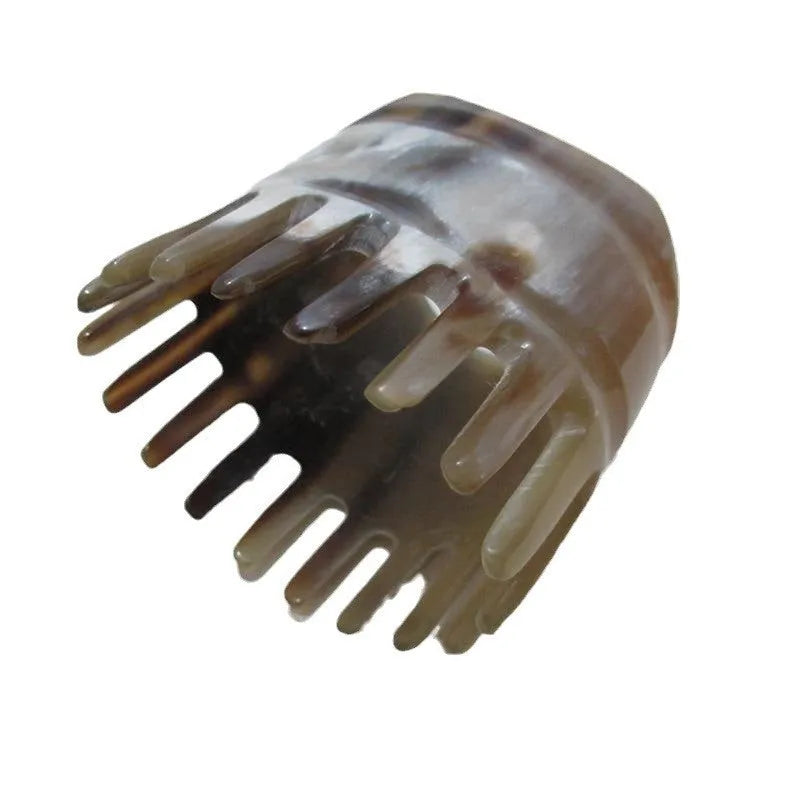 Black buffalo horn head massage comb with wide-tooth, pointed tip, and fine-tooth sections