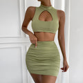 Light purple women's two-piece set with hollow-out vest top and split skirt on a model.