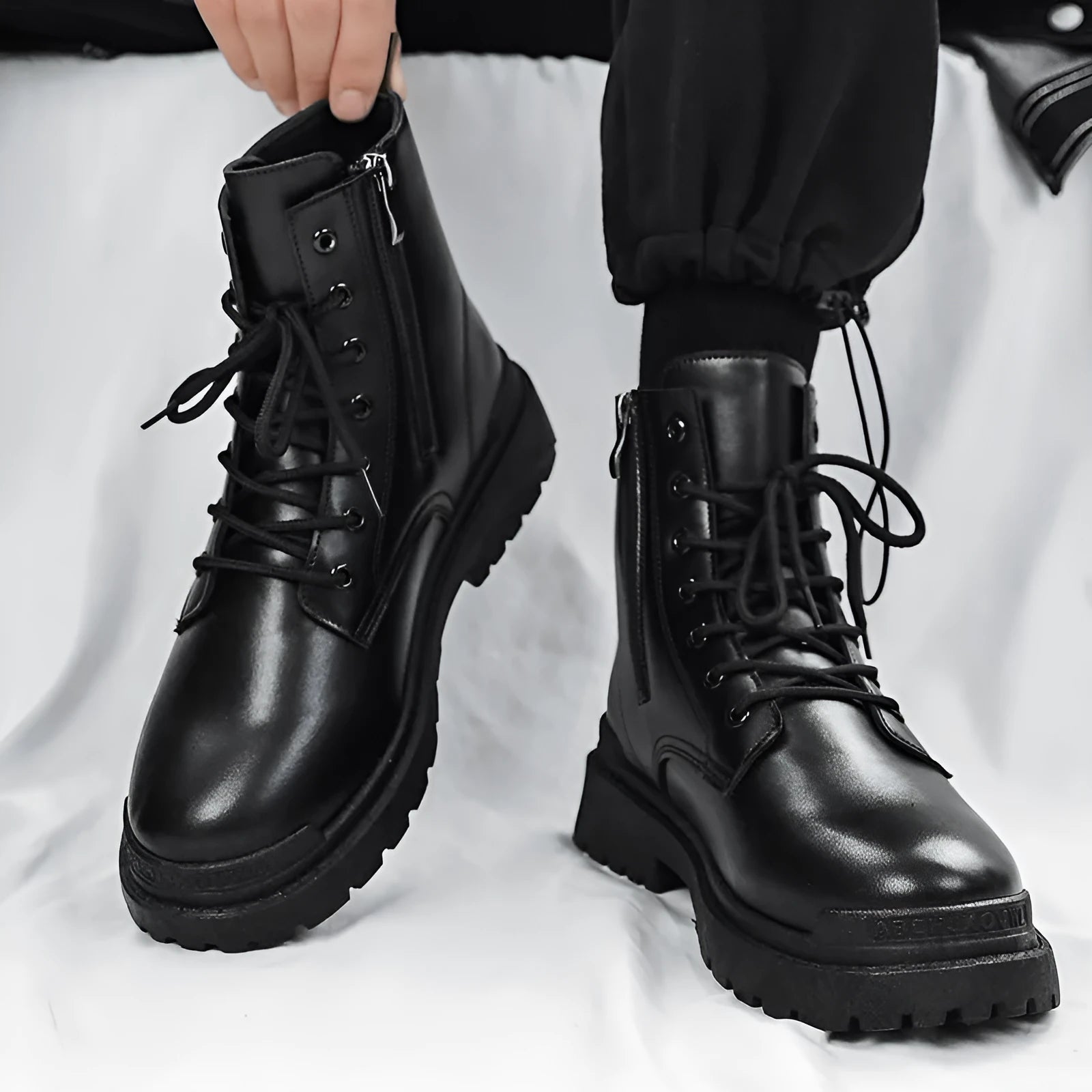 Men's black British style mid-top leather ankle boots with rubber sole.