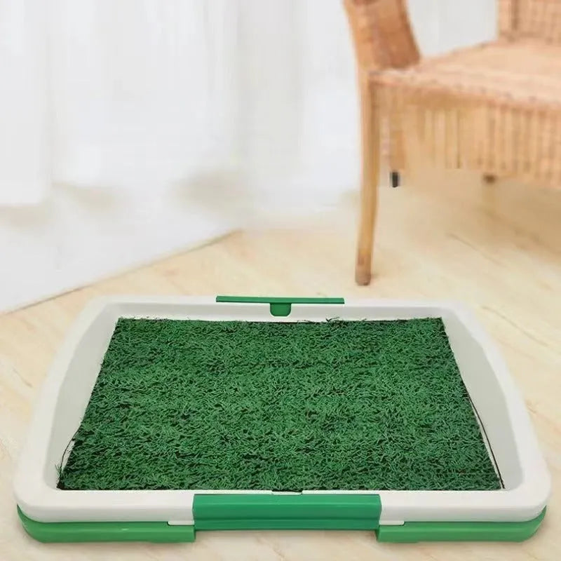 Green artificial grass dog toilet training tray with plastic base and collection basin.