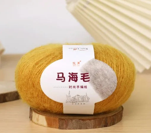DIY mohair scarf weaving kit showing one wool ball and a selection of 34 colour options including white, pink, blue and green.