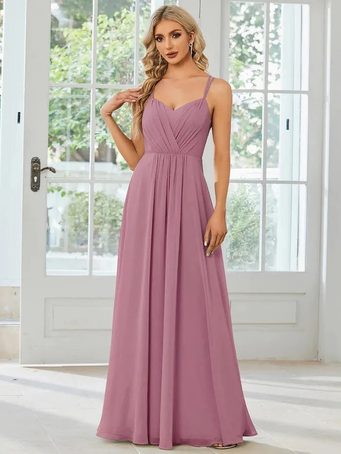 Women's long pleated sleeveless A-line dress in light green, shown on a mannequin.