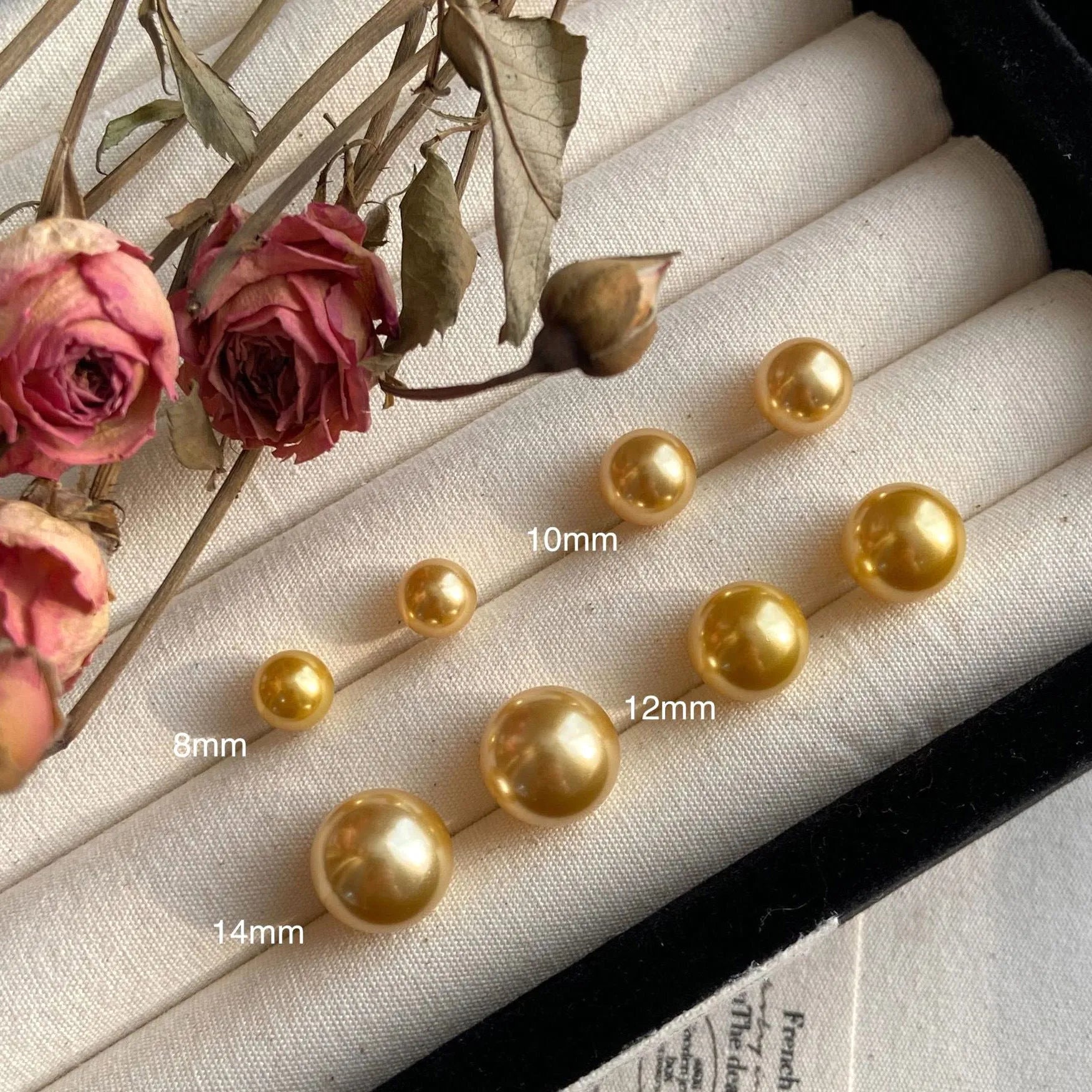 A pair of large geometric pearl stud earrings for women in silver, showing an eight-point star design detail.