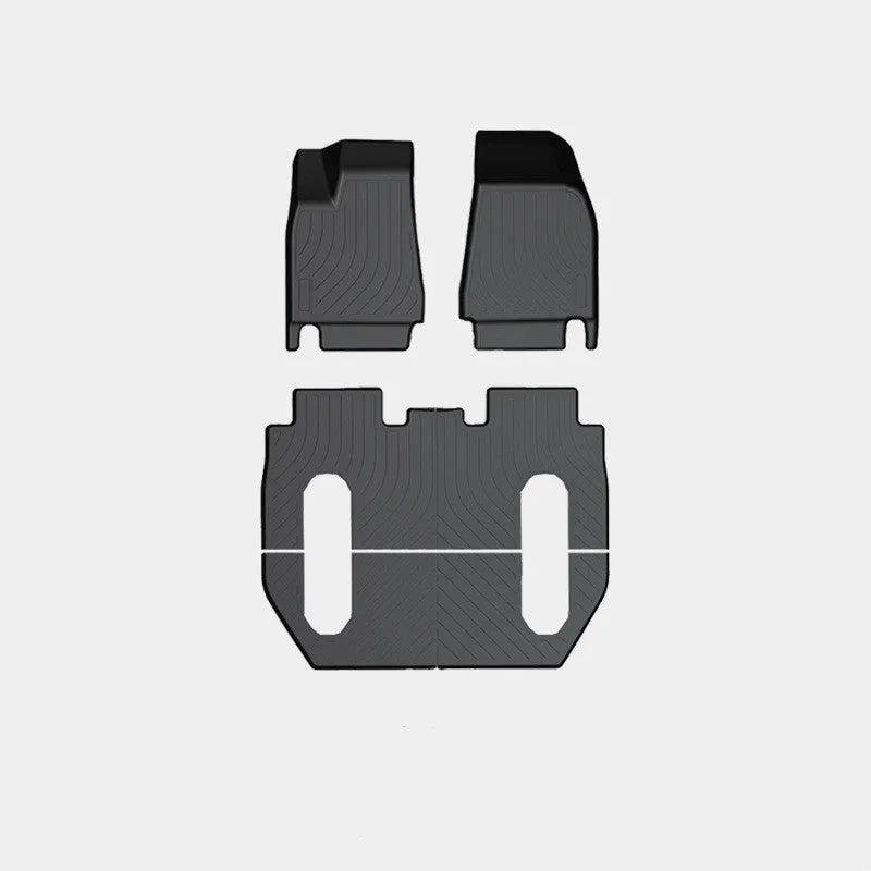 Tesla Model X black TPE rubber floor mats and boot liner set on car interior.