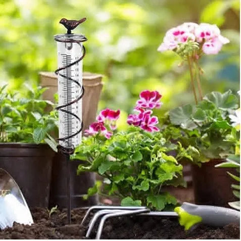 Cast iron bird garden rain gauge with glass measuring tube showing hummingbird design