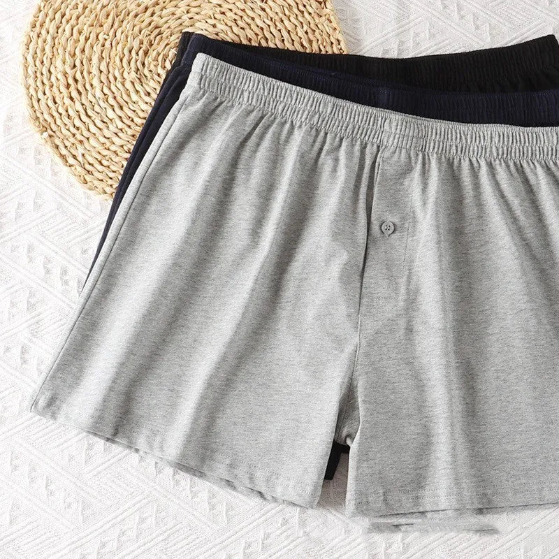Men's solid colour loose-fit cotton boxer shorts on a white background, showing high waist and leg openings.