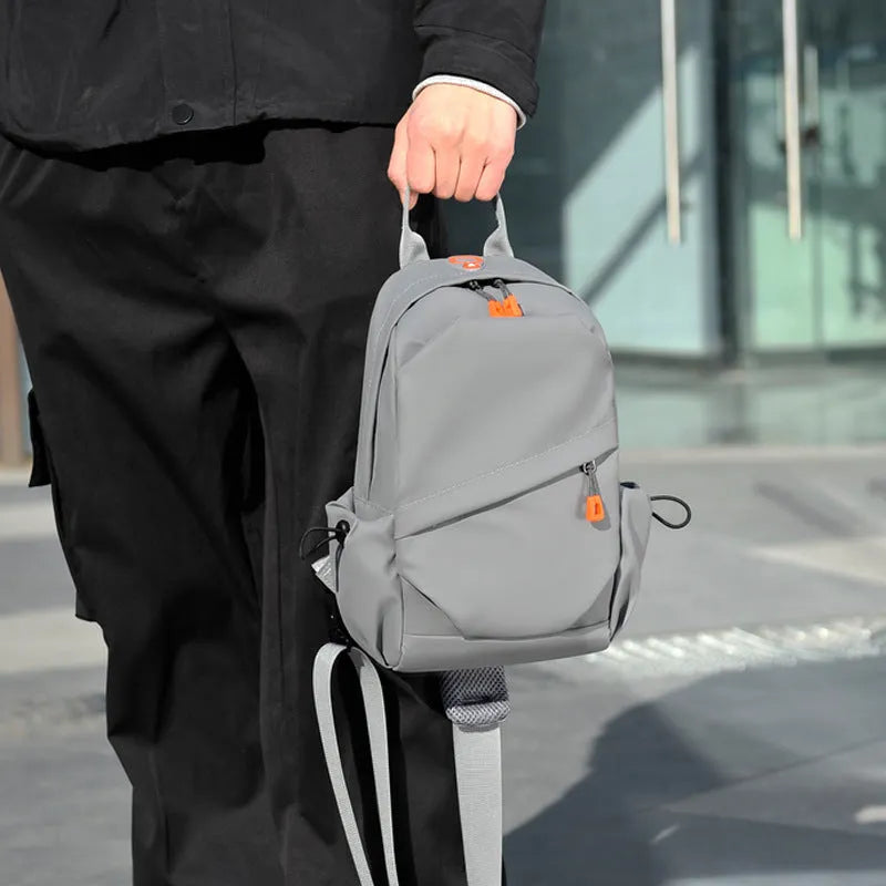 Men's black casual crossbody bag made from waterproof polyester with an adjustable shoulder strap.