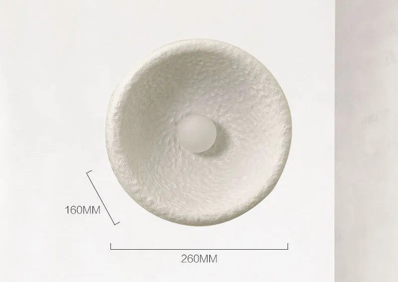 Japanese-style minimalist wall lamp with resin shade in three diameter options on modern interior wall