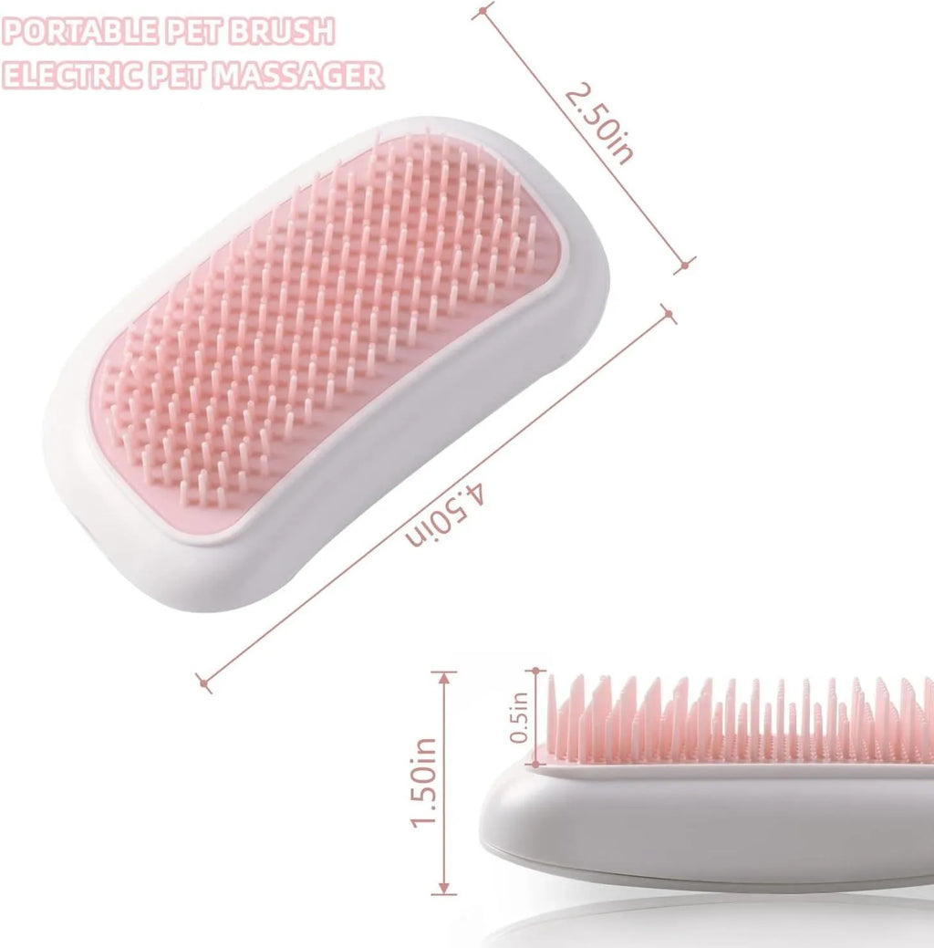 Handheld pink and white electric pet massage brush for cats and dogs on a table.