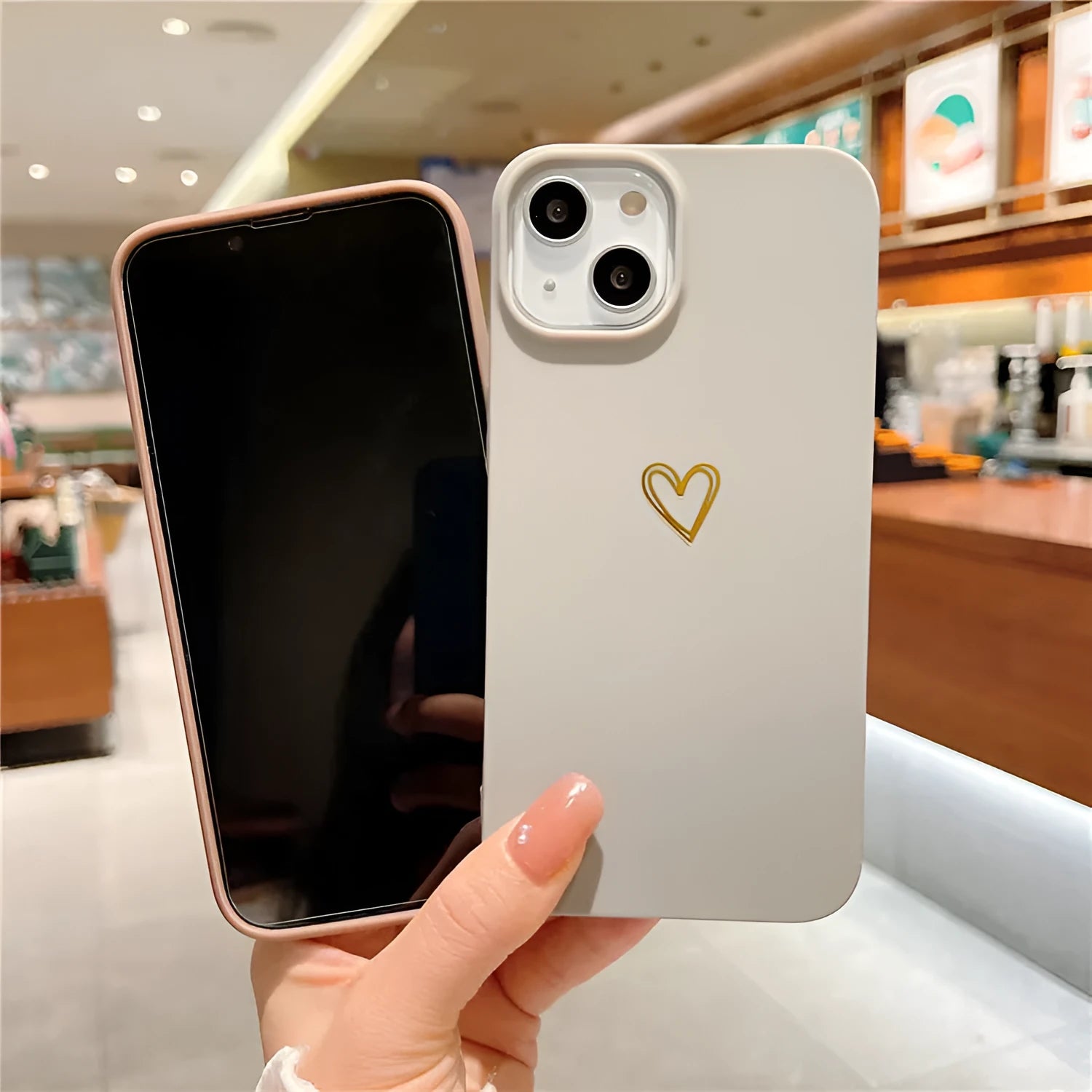 Brown silicone iPhone case with a hot-stamped love heart design on the back