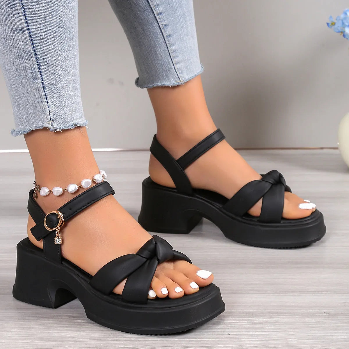 Black thick-heel high heel slippers with button closure and round toe design