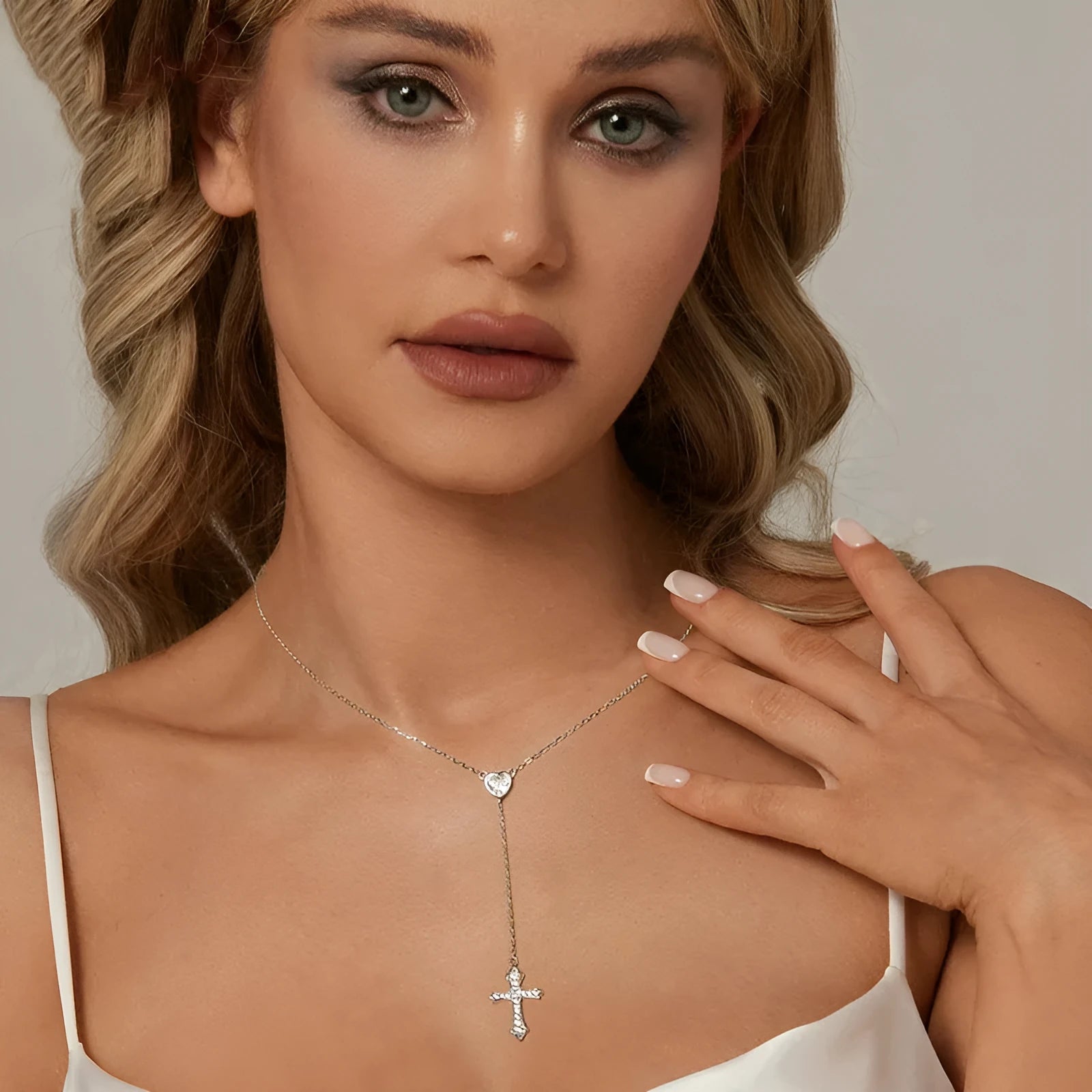 Simple sterling silver V-neck cross pendant necklace on an O-ring chain, colour BSN384.