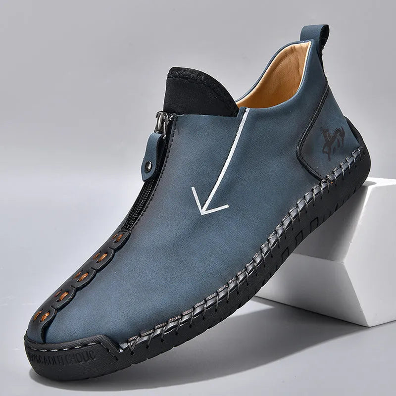 Men's black casual ankle boots with a front zip closure and visible stitching detail