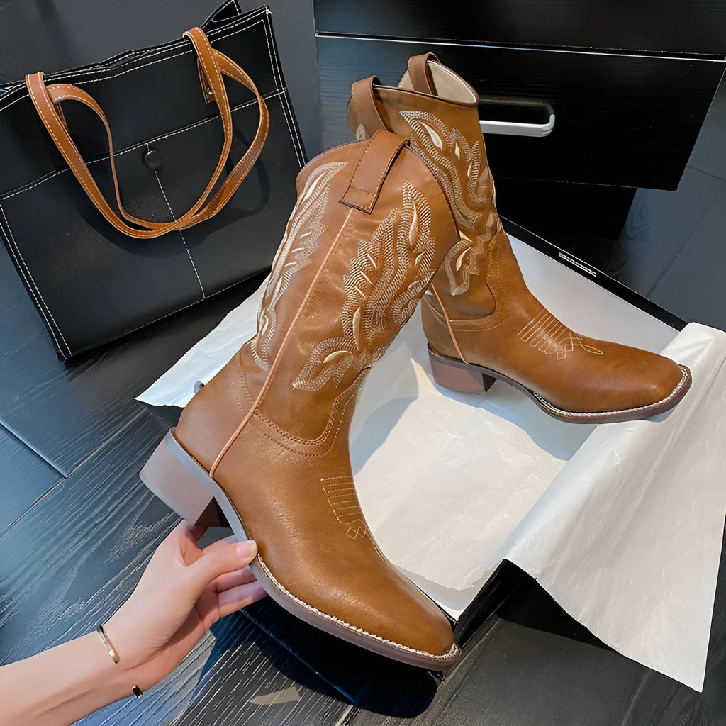 Brown women's mid-calf Martin boots with embroidered pattern, leather lining, and a square rubber sole.
