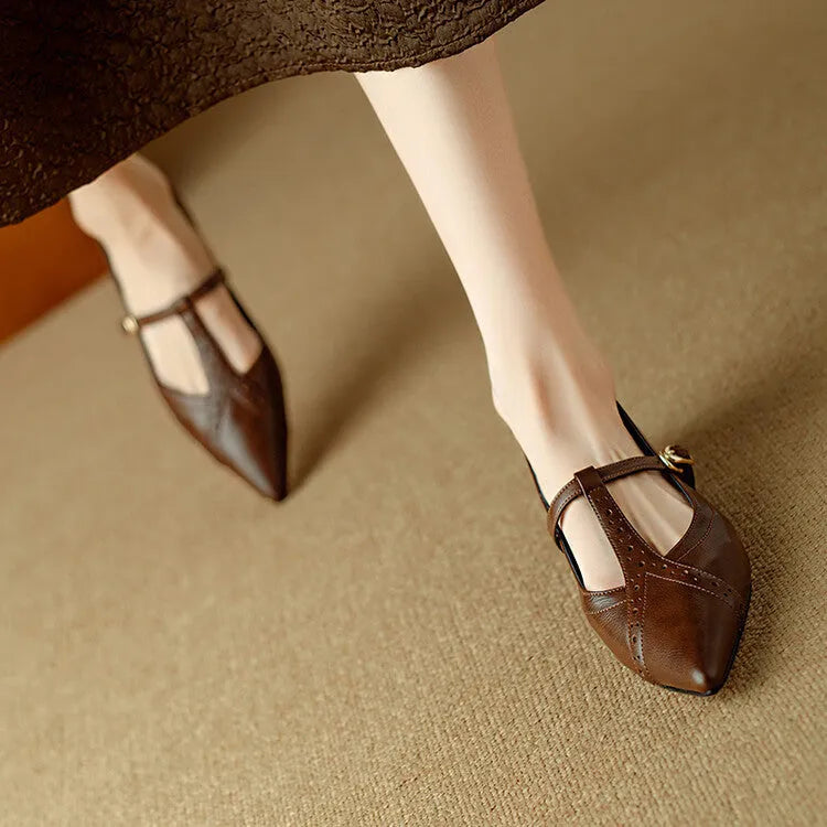 Brown women's round-toe flat shoes with a low heel and metal detail on a leather upper.