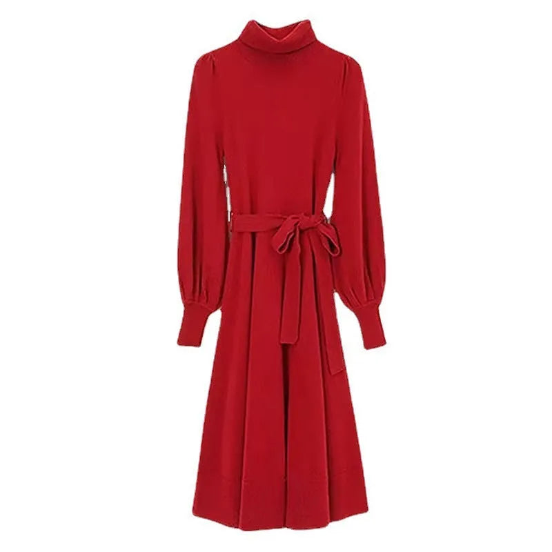 Loose-fitting turtleneck knit dress in rose red with long sleeves and a mid-length skirt.