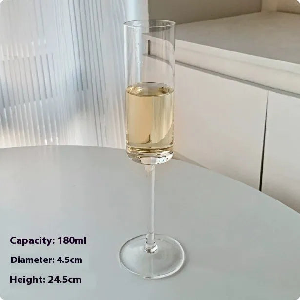 A single clear French goblet champagne glass on a table.