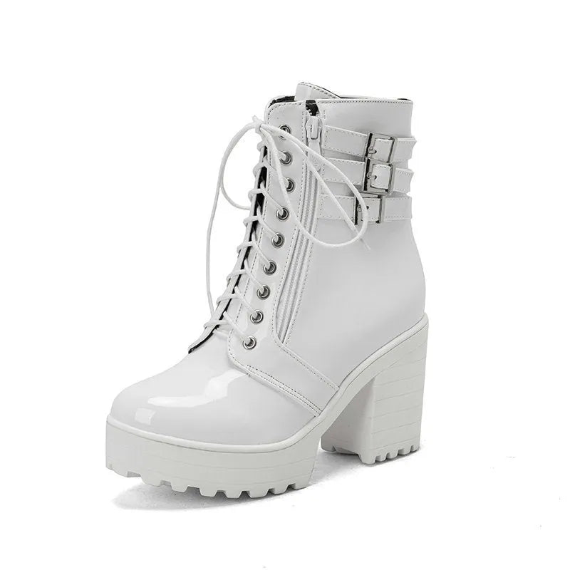 Women's black ankle boots with thick heel, round toe, and front lace-up on a waterproof platform sole.