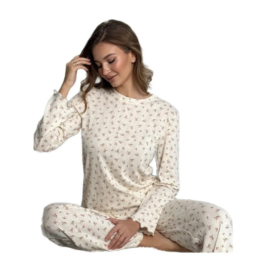 White floral print women's bell sleeve top and wide leg trousers suit on hanger
