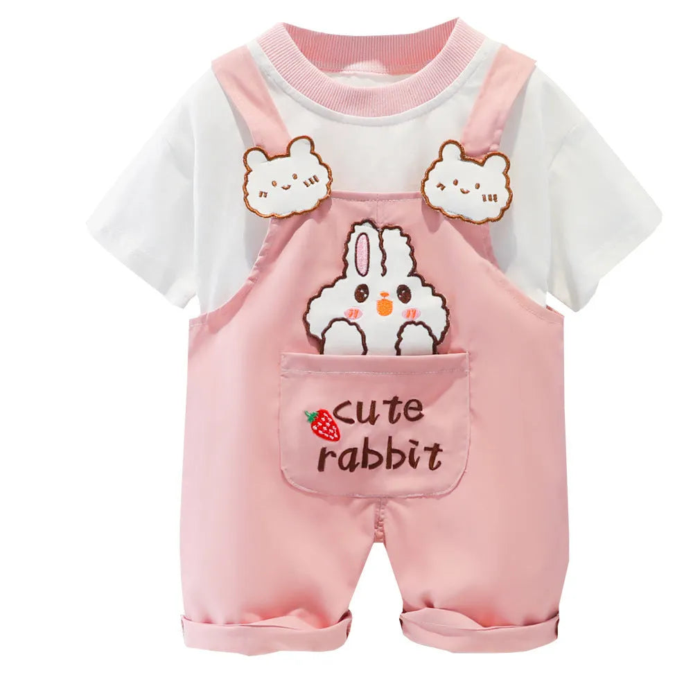 Yellow cotton baby romper with cartoon print and openable shoulder straps, laid flat.