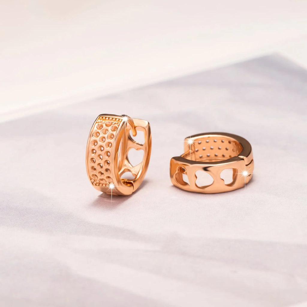 Rose gold electroplated earrings with three hollow heart shapes in circular design