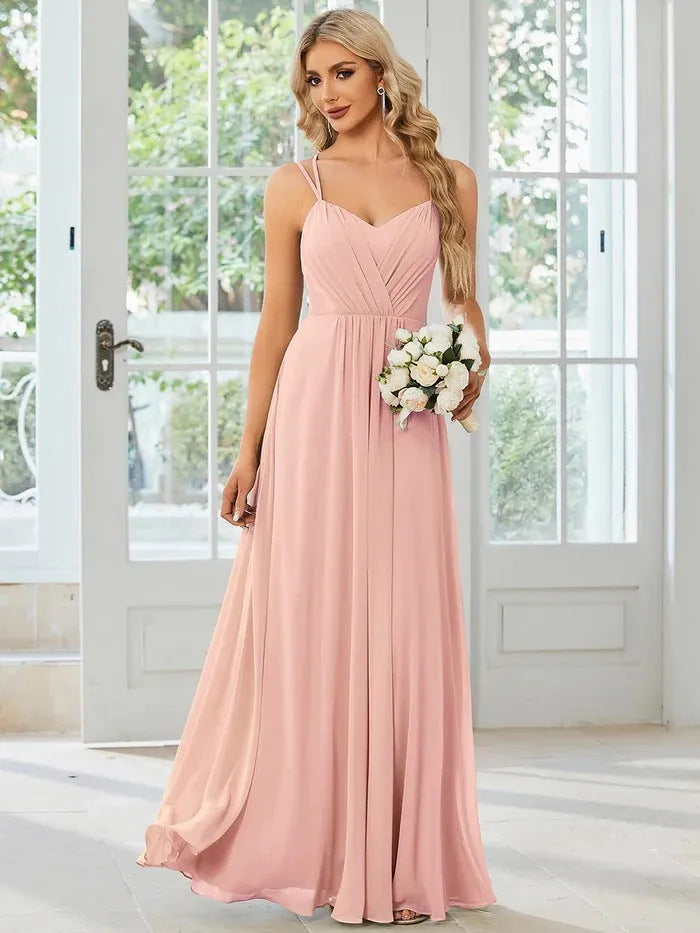 Women's long pleated sleeveless A-line dress in light green, shown on a mannequin.