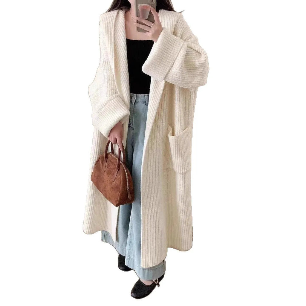 Loose hooded acrylic cardigan coat for women in beige, showing long length and raglan sleeves.
