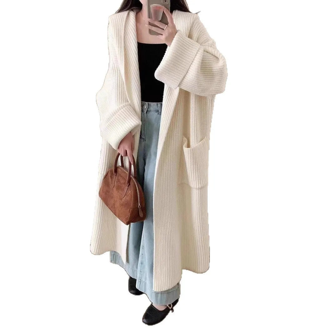 Loose hooded acrylic cardigan coat for women in beige, showing long length and raglan sleeves.