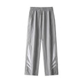 Men's black straight leg loose fit summer sports trousers with an elastic waist on a grey background.
